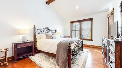 a bedroom with a bed and a dresser and a television at Snowcreek The Lodges #1130 condo in Mammoth Lakes