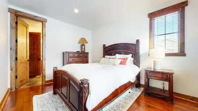 a bedroom with a large bed and a mirror at Snowcreek The Lodges #1130 condo in Mammoth Lakes