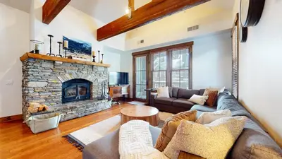 a living room with a couch and a fireplace at Snowcreek The Lodges #1130 condo in Mammoth Lakes