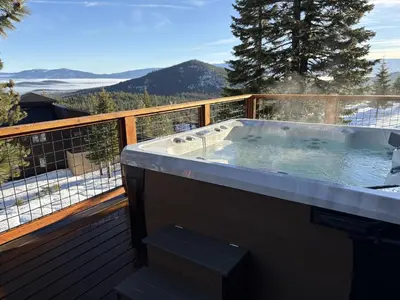 a jacuzzi tub on the deck of a house at Tahoe Donner Pinnacle Loop Mountain Retreat home in Truckee