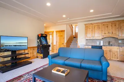 a living room with a blue couch and a tv at Tahoe Donner Pinnacle Loop Mountain Retreat home in Truckee