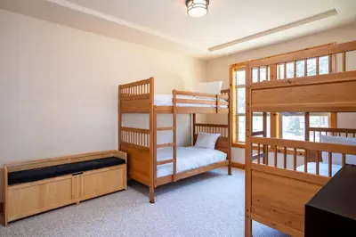 a bedroom with two bunk beds and a bed at Tahoe Donner Pinnacle Loop Mountain Retreat home in Truckee