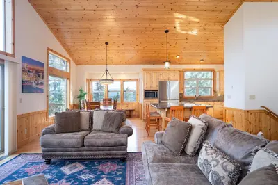 a living room with two couches and a kitchen at Tahoe Donner Pinnacle Loop Mountain Retreat home in Truckee