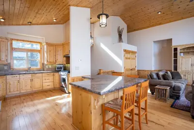 a kitchen and living room with a large island at Tahoe Donner Pinnacle Loop Mountain Retreat home in Truckee