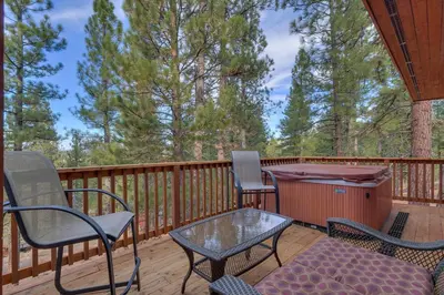 a deck with chairs and a table and a grill at Northstar Conifer Luxury Home home in Truckee