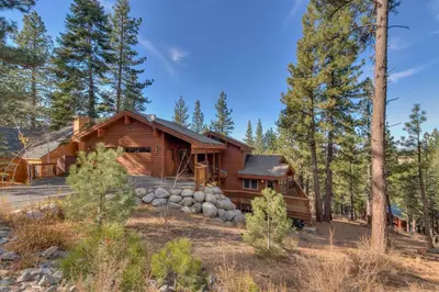 a log cabin in the woods with trees at Northstar Conifer Luxury Home home in Truckee