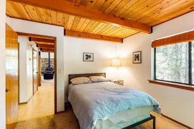 a bedroom with a bed and a wooden ceiling at The Arrow House in Camp Connell