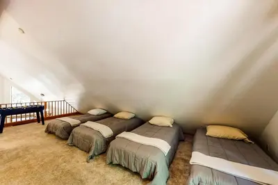 a bedroom with three beds in a room at The Arrow House in Camp Connell