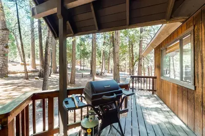 a motorcycle parked on a porch of a cabin at The Arrow House in Camp Connell