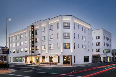 a white building on the corner of a street at El Capitan Hotel in Merced