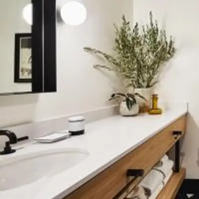 a bathroom with a sink and a mirror at El Capitan Hotel in Merced