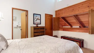 a bedroom with a bed and a wooden bunk bed at Val D'Isere #17 condo in Mammoth Lakes