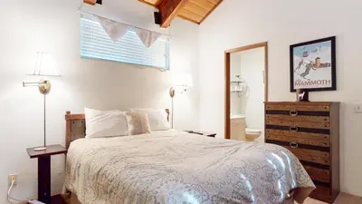 a bedroom with a bed and a dresser and a window at Val D'Isere #17 condo in Mammoth Lakes