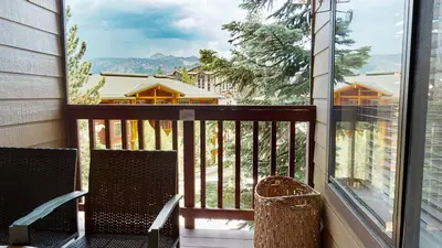 a balcony with two chairs and a view of a house at Val D'Isere #17 condo in Mammoth Lakes