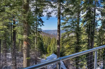 a view of the mountains from a deck in the woods at Canyons Crest in Yosemite West