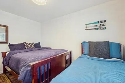 a bedroom with two beds and a sign on the wall at Piney Retreat in Carnelian Bay