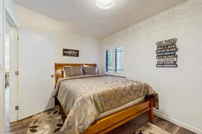 a bedroom with a bed and a sign on the wall at Piney Retreat in Carnelian Bay