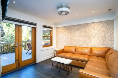 a living room with a couch and a table at Cedar Crest - Eagle Cottage 8 in Homewood