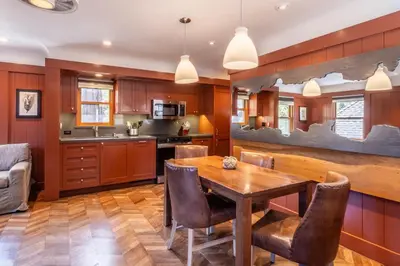 a kitchen with a wooden dining room table and chairs at Cedar Crest - Robin Cottage 6 in Homewood