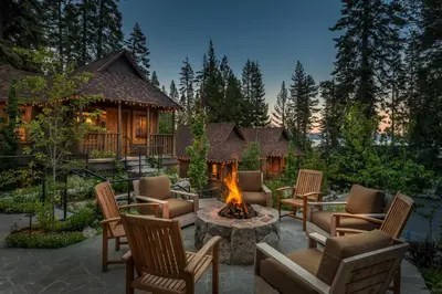 a backyard with a fire pit and chairs and a cabin at Cedar Crest - Sparrow Cottage 1 in Homewood