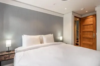 a bedroom with a large white bed with two lamps at Cedar Crest-Stellars Jay Cottage 4 in Homewood