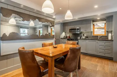 a kitchen with a wooden table and chairs at Cedar Crest-Stellars Jay Cottage 4 in Homewood