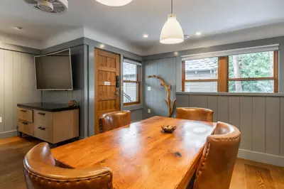 a dining room with a wooden table and chairs at Cedar Crest-Stellars Jay Cottage 4 in Homewood