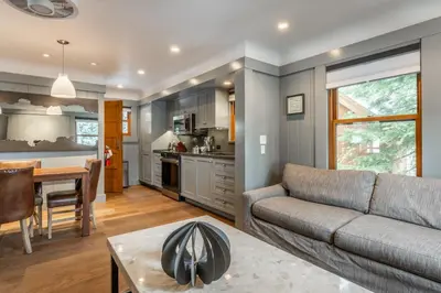 a living room with a couch and a table at Cedar Crest-Stellars Jay Cottage 4 in Homewood