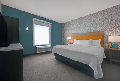 a bedroom with a large bed and a television at Home2 Suites By Hilton Tracy, Ca in Tracy