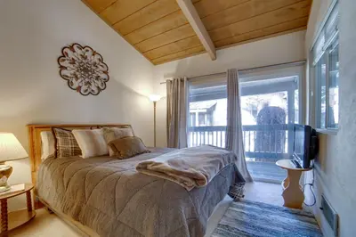 a bedroom with a bed and a large window at Resort Condo with Hot Tub and Pool, Near Ski Lift in Mammoth Lakes
