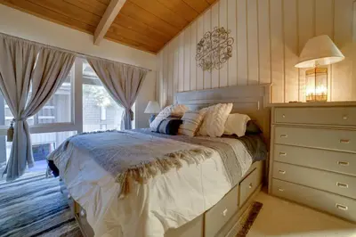 a bedroom with a bed and a dresser and a window at Resort Condo with Hot Tub and Pool, Near Ski Lift in Mammoth Lakes