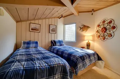 two beds in the corner of a room at Resort Condo with Hot Tub and Pool, Near Ski Lift in Mammoth Lakes