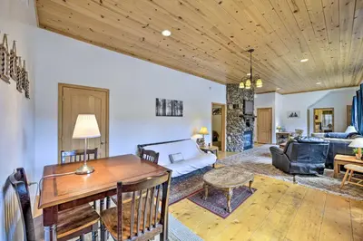 a living room with a wooden ceiling at Secluded Camp Connell Home with Deck and Fireplace! in Camp Connell