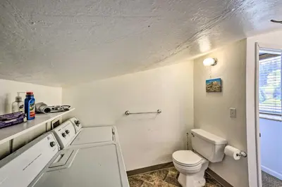 a small bathroom with a toilet and a sink at Secluded Camp Connell Home with Deck and Fireplace! in Camp Connell