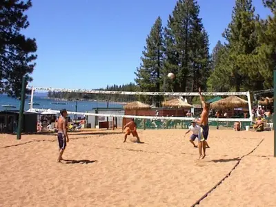 a group of men playing volleyball on a beach at LUXE 4 Blue Diamond Lake Tahoe Lodge in Stateline