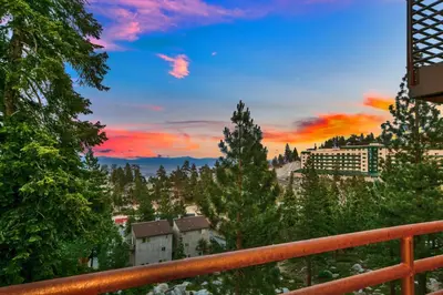 a view of a city from a balcony at sunset at LUXE 11 Blue Diamond Lodge Lake Tahoe in Stateline