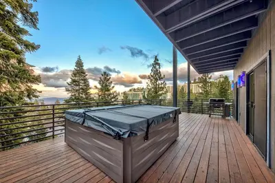 a hot tub on the deck of a house at LUXE 11 Blue Diamond Lodge Lake Tahoe in Stateline