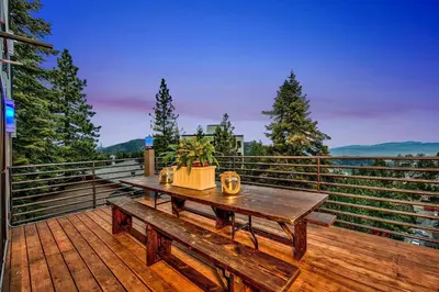a wooden table on the deck of a house at LUXE 11 Blue Diamond Lodge Lake Tahoe in Stateline
