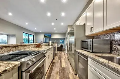 a kitchen with marble counter tops and stainless steel appliances at LUXE 11 Blue Diamond Lodge Lake Tahoe in Stateline