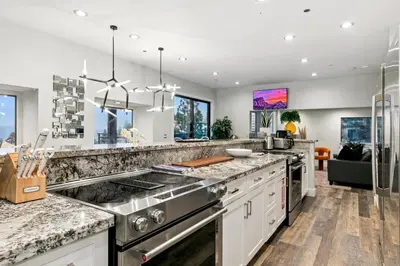 a kitchen with stainless steel appliances and granite counter tops at LUXE 11 Blue Diamond Lodge Lake Tahoe in Stateline