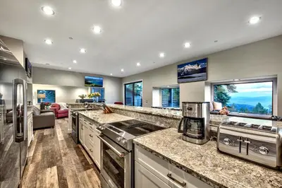 a kitchen with granite counter tops and a living room at LUXE 11 Blue Diamond Lodge Lake Tahoe in Stateline