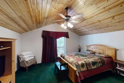 a bedroom with a bed and a ceiling fan at Papas Mountain in Shaver Lake