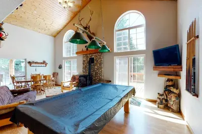 a living room with a pool table in it at Papas Mountain in Shaver Lake