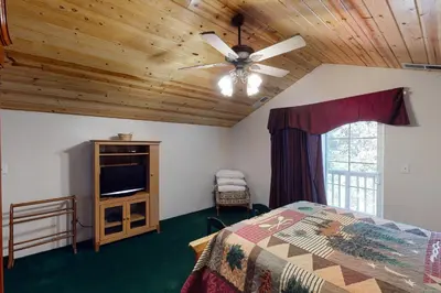 a bedroom with a bed and a ceiling fan at Papas Mountain in Shaver Lake