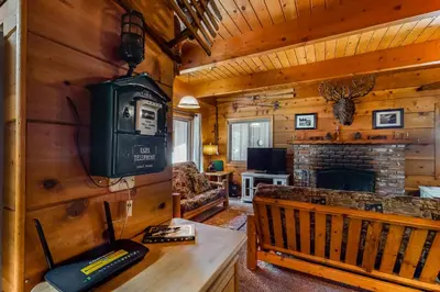 a living room with a tv and a fireplace in a cabin at Williams Cabin in Shaver Lake