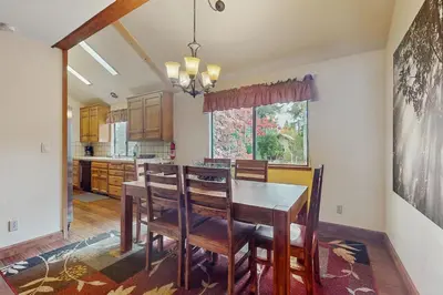 a dining room with a table and chairs and a kitchen at Whispering Pines in Shaver Lake