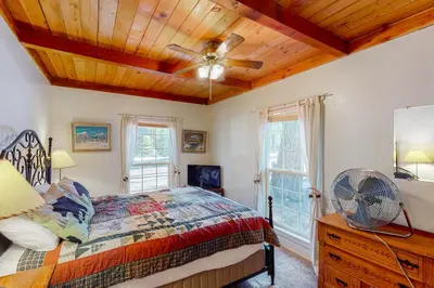 a bedroom with a bed and a ceiling fan at Maul Cabin in Shaver Lake