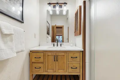 a bathroom with a sink and a mirror at Private Beach Retreat in Zephyr Cove