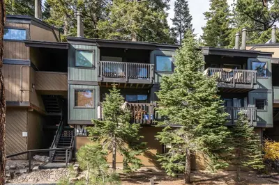 an apartment building with balconies and trees at Bigwood 32 in Mammoth Lakes