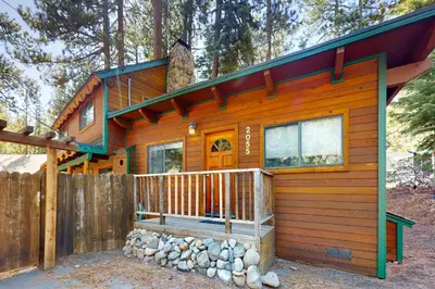 a cabin in the woods with a fence at Tahoe Delight in Tahoe City